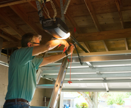 technician repairing garage door opener