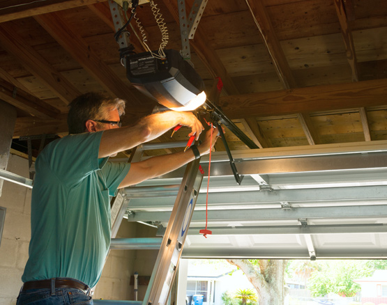 technician repairing garage door chain