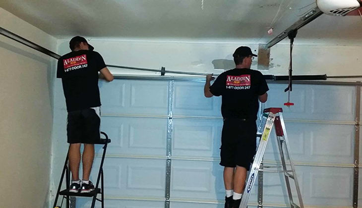 aladdin technicians replacing garage door spring